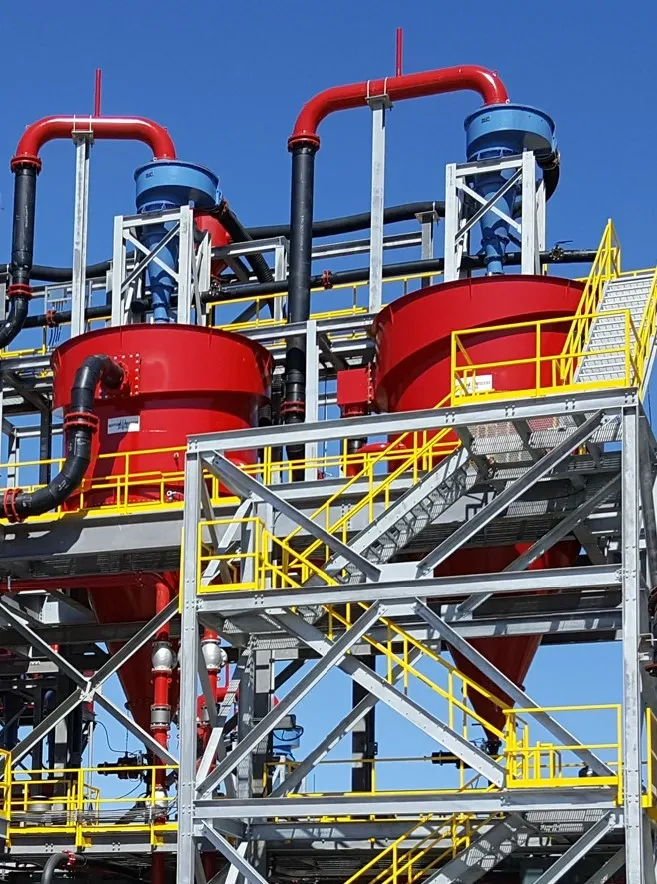 A red and yellow structure with pipes on top of it.