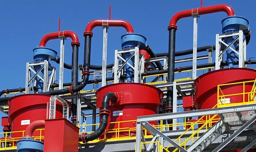 A red and yellow industrial plant with pipes