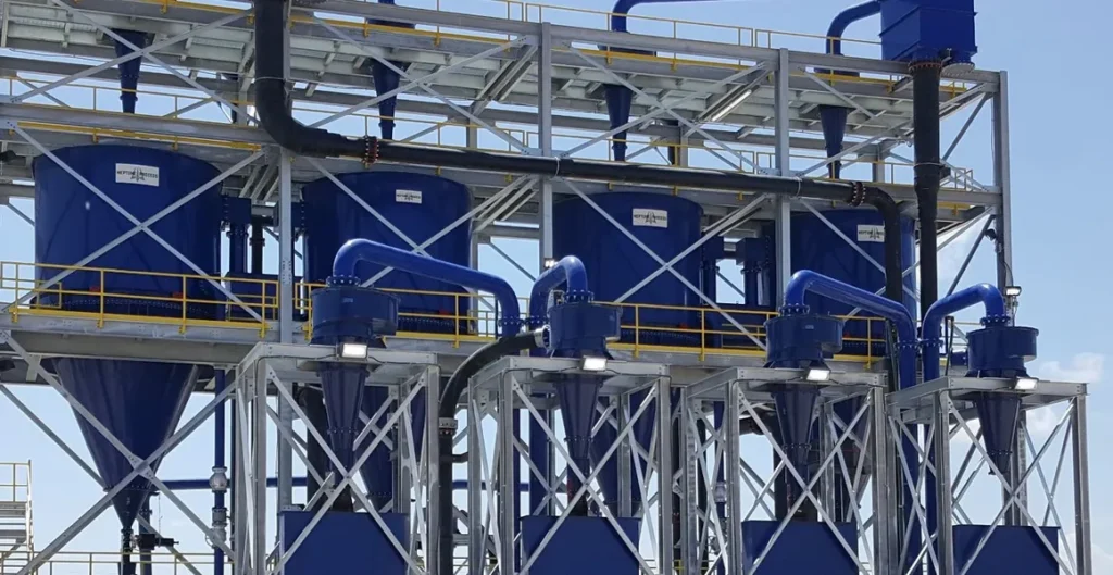 A large blue machine is in the middle of a factory.