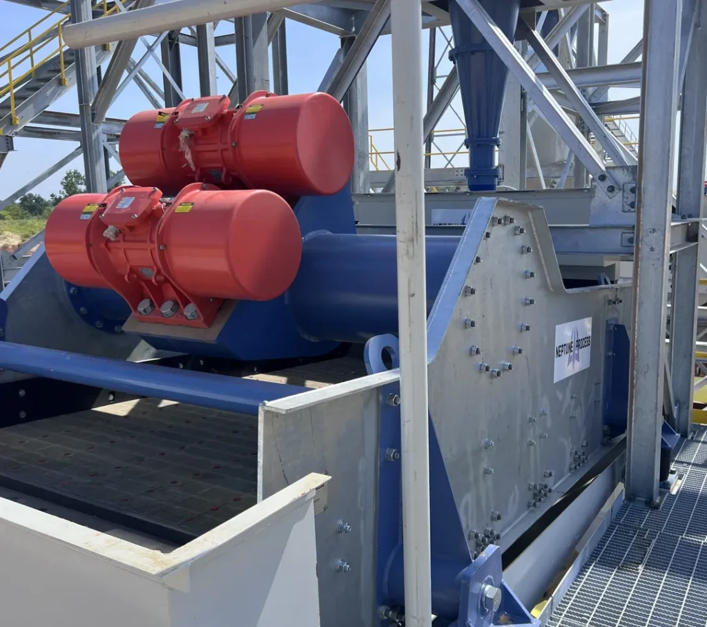 A large machine with red barrels on top of it.
