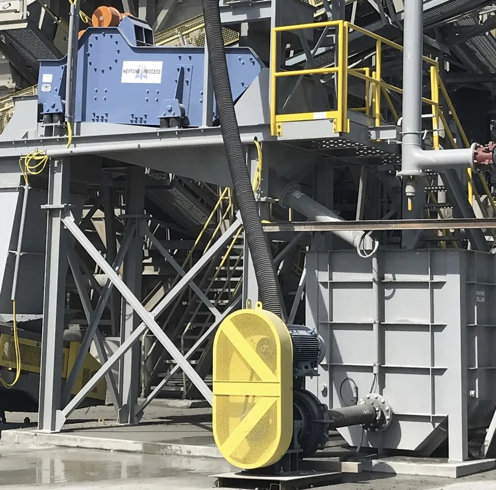 A yellow fan is on the side of a building.