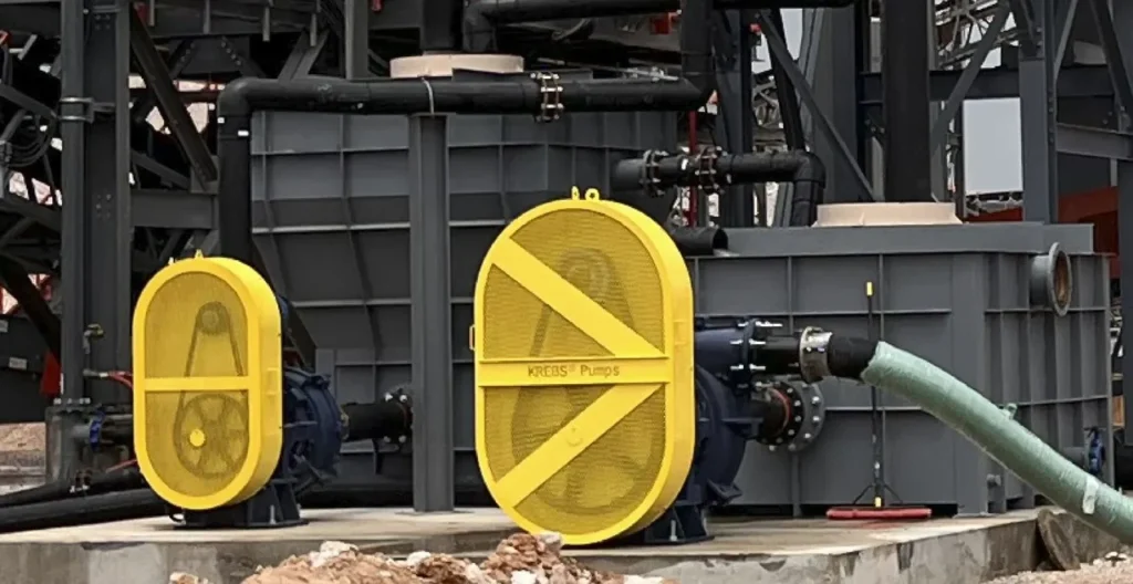 A yellow piece of metal sitting on top of concrete.